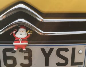 Santa-on-Yellow-Car-Radiator-Grill-by-John-Griffiths-ColbyCi