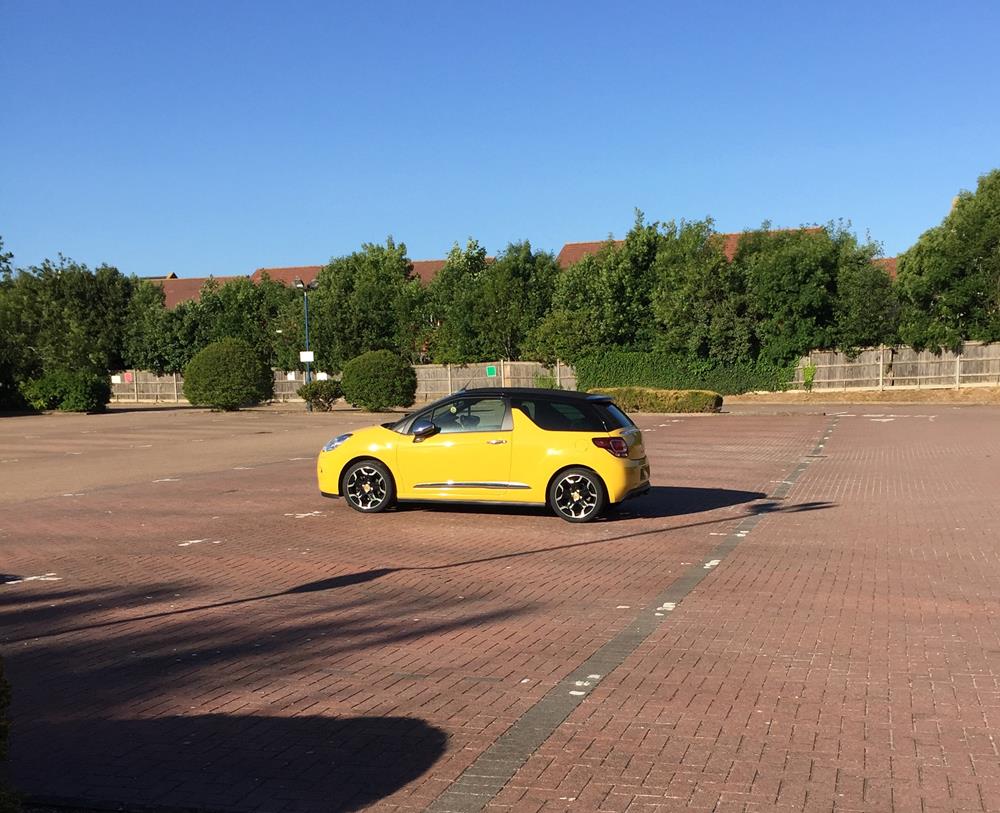 Yellow car parked in an empty car park