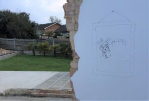 Scribbled painting on a wall overlooking a garden