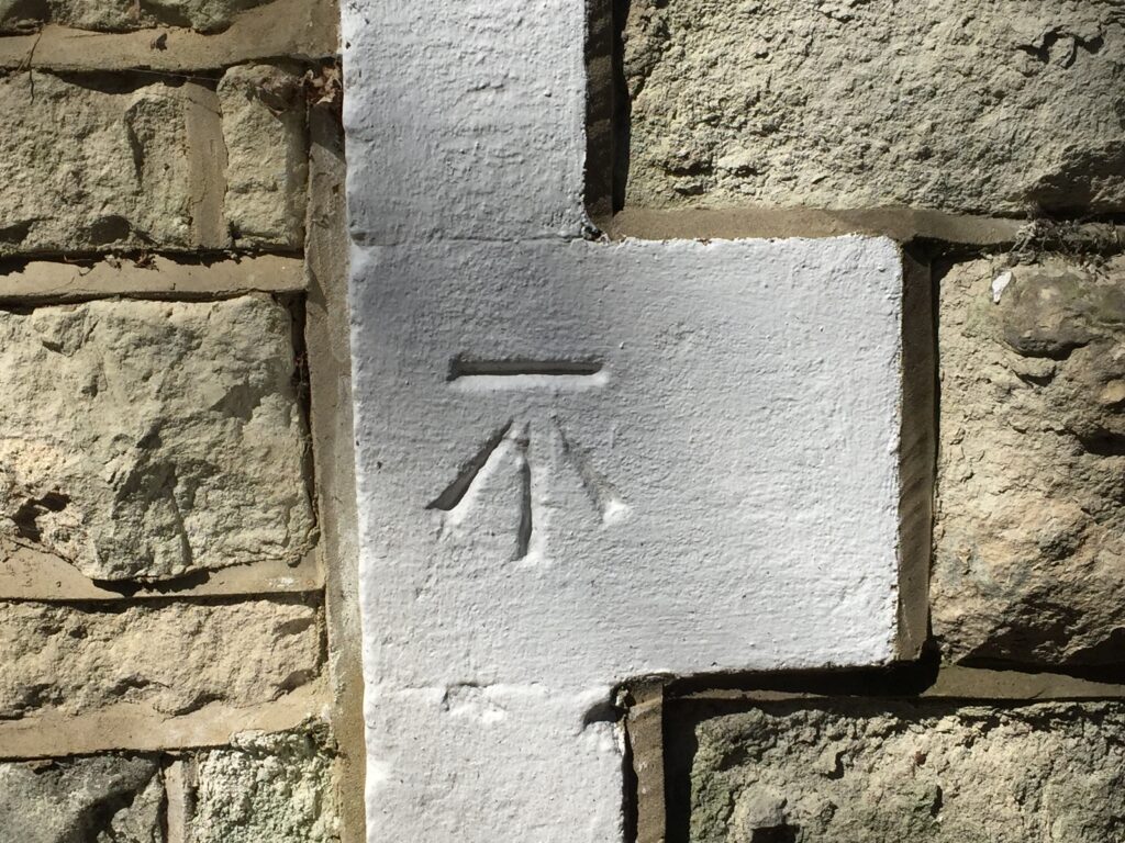 ordnance-survey-arrow-pushing-up-against-bar-by-John-Griffiths-Colby